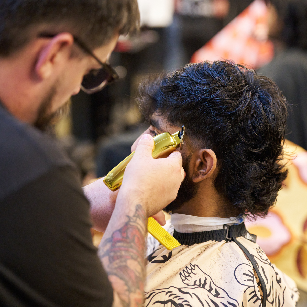 A photo of a barber cutting a customers hair
