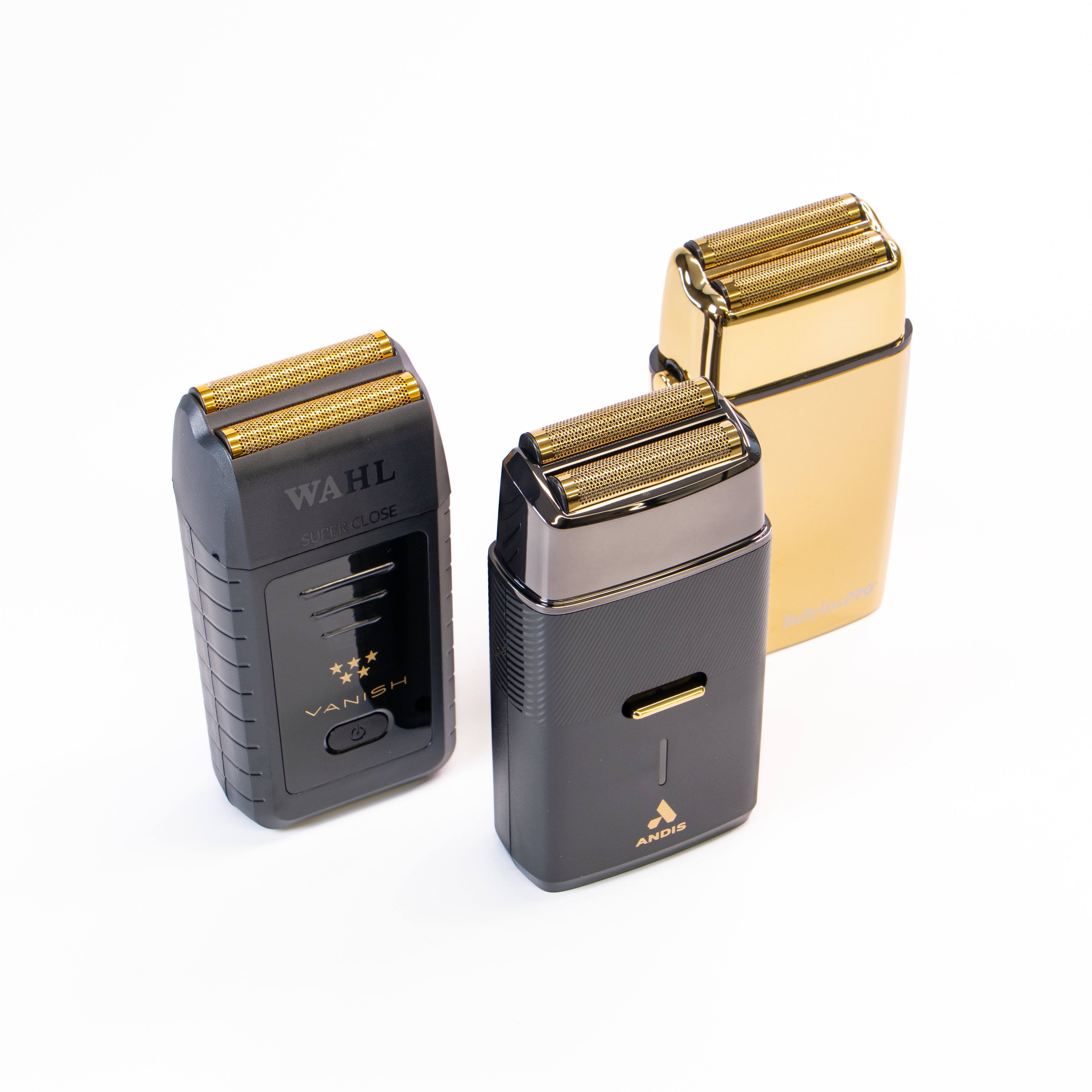 Three electric shavers in gold and black on a white background